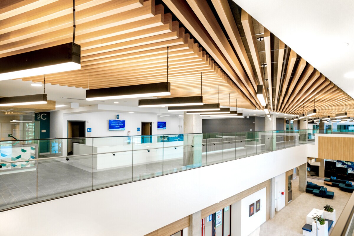 A photo of a healthcare building with Maxxit's LINE:Form Traditional Baffles finished in Champagne Pine at Covenant Health Centre in Edmonton, CA