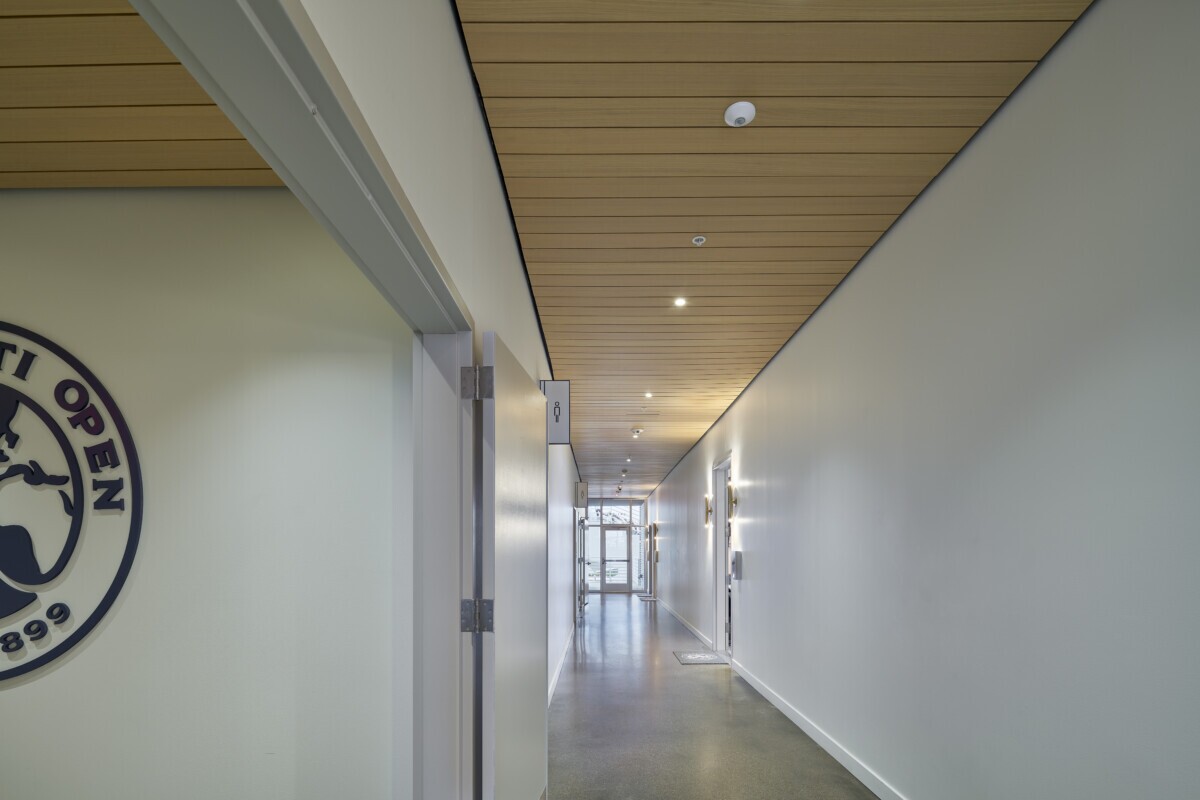 LINE:form linear plank ceilings in a hallway at the Lindner Family Tennis Center's Suites area and performance center