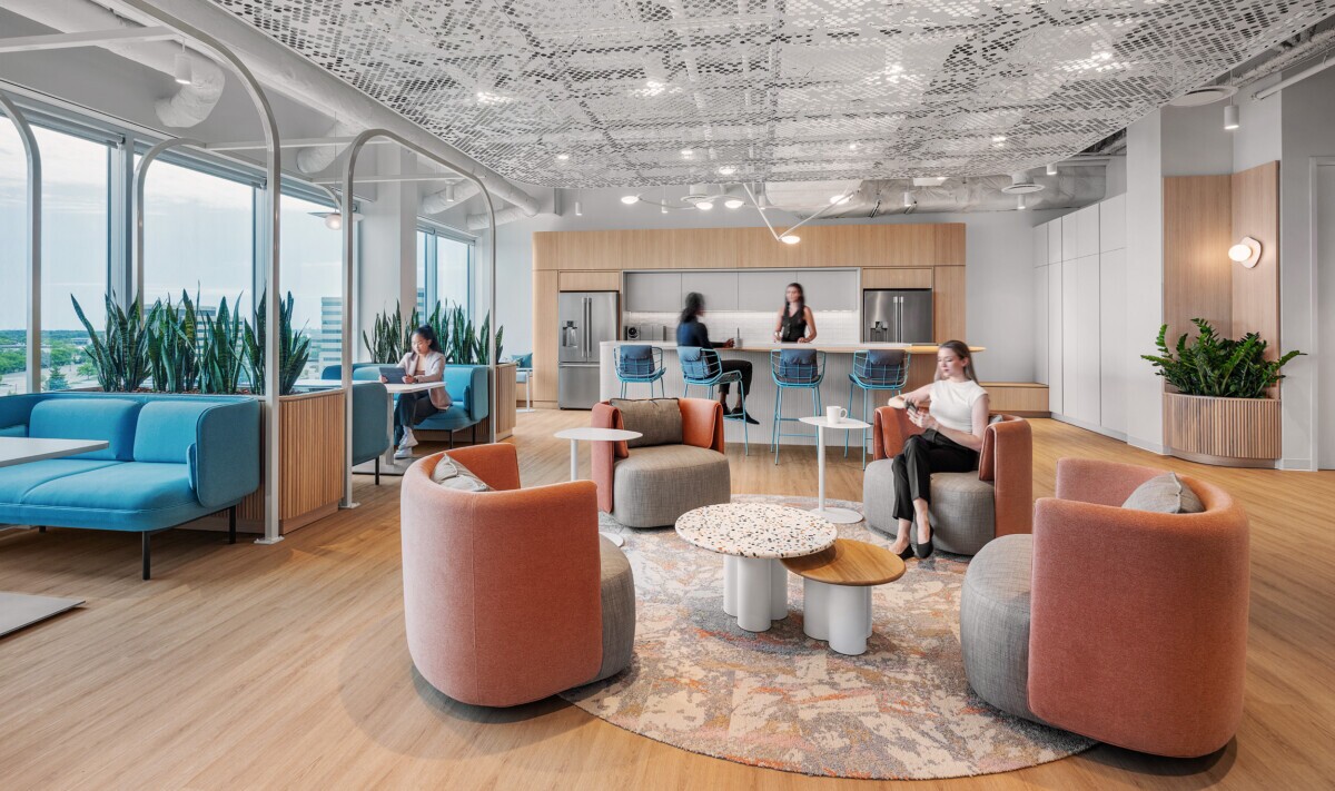 A lounge area and kitchen with PANEL:form Design perforated ceiling panels at Smith Nephew