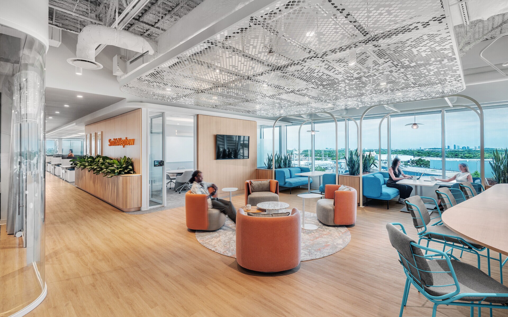 A lounge area in an office space with PANEL:form design perforated ceiling panels at Smith Nephew