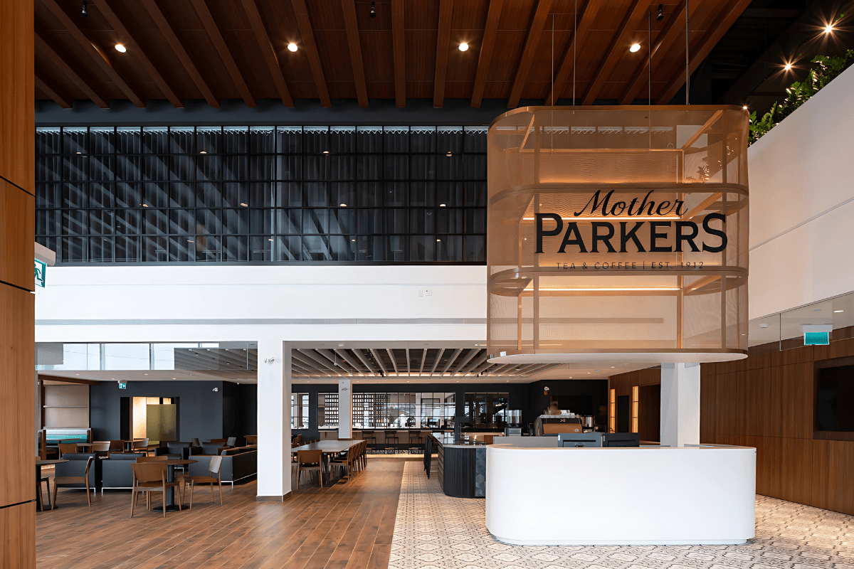 Mother Parkers atrium featuring a custom bronze metal mesh hanging basket above the reception.