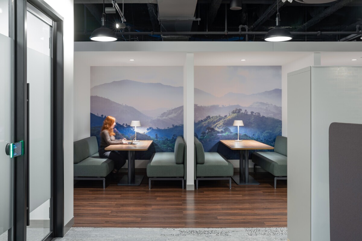 Mother Parkers office booths featuring custom landscape wall graphics and modern lighting.