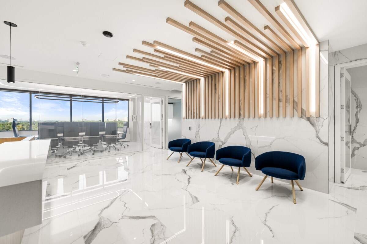 Modern reception desk at Jilani Group with Agilis wood-look ceiling and wall slats.