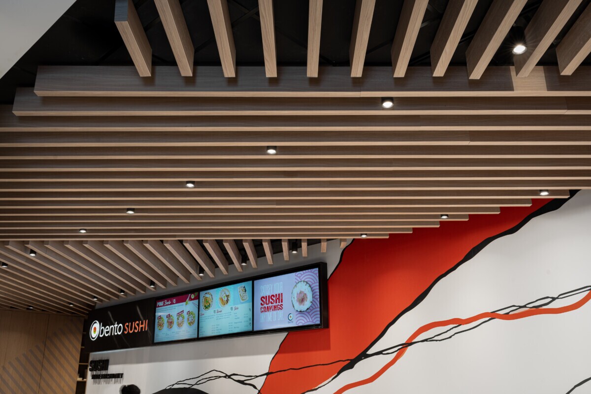 Agilis traditional wood-look baffles integrated with lighting at Bento Sushi.