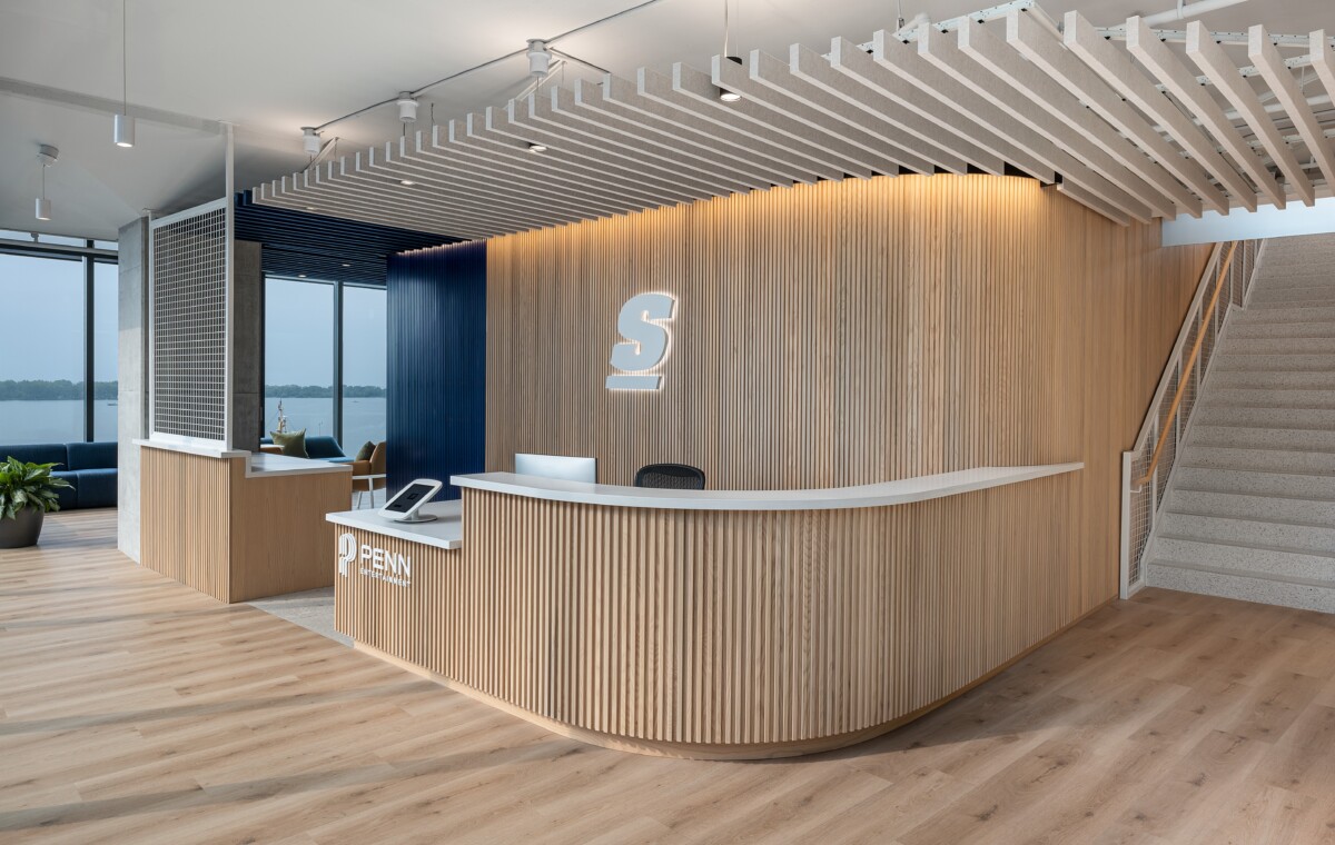 theScore Toronto reception featuring Silentia profile acoustic baffles and curved wood-slat wall design.