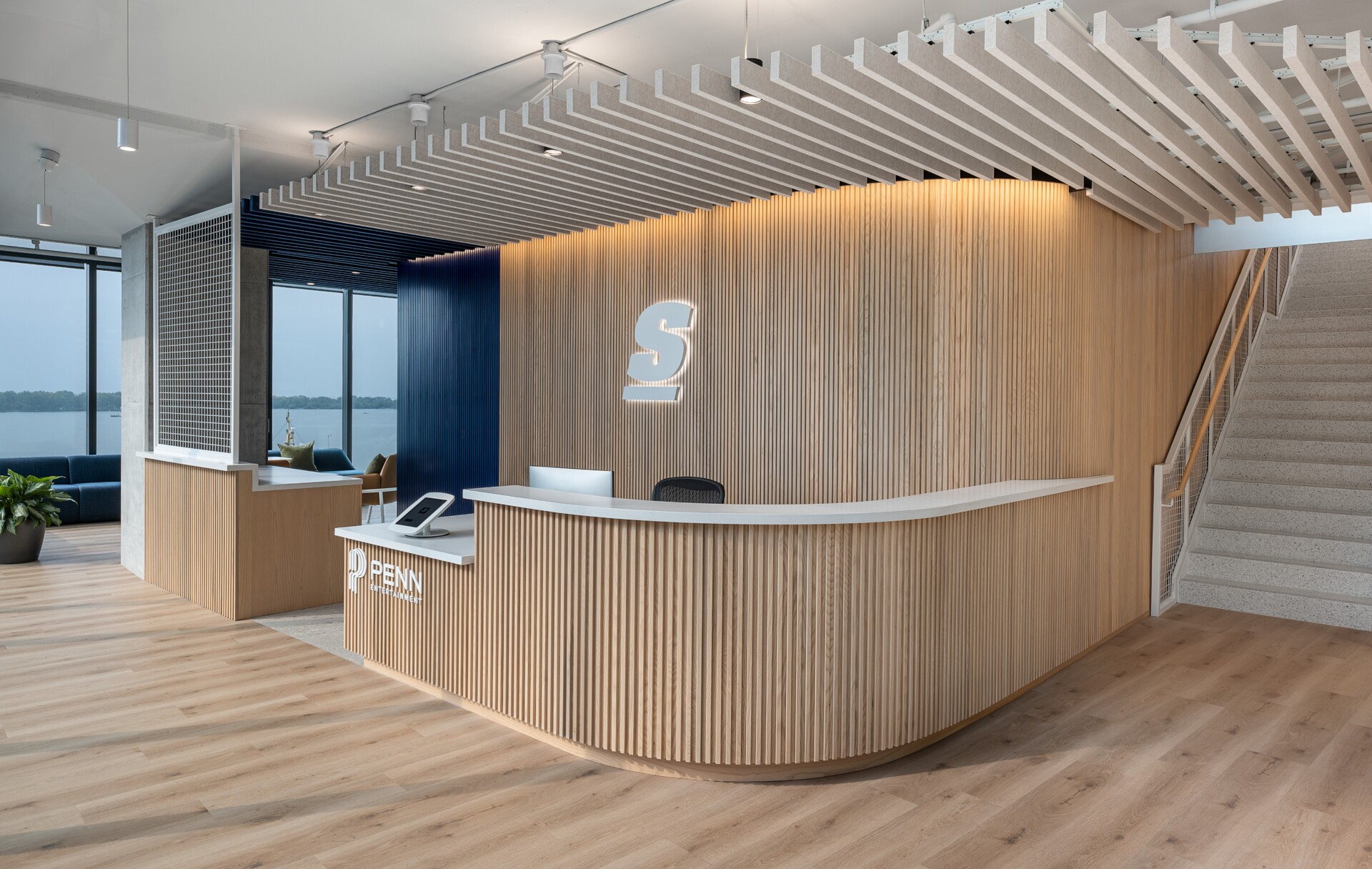 theScore Toronto reception featuring Silentia profile acoustic baffles and curved wood-slat wall design.