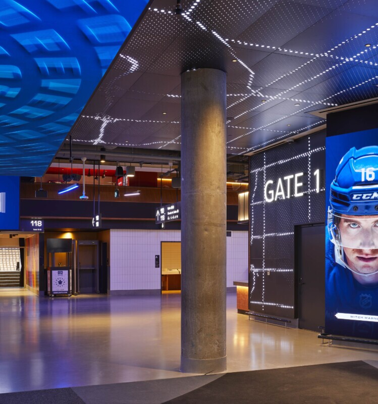 Scotiabank Arena concourse featuring Agilis backlit, custom-perforated ceiling and wall panels at Gate 1.