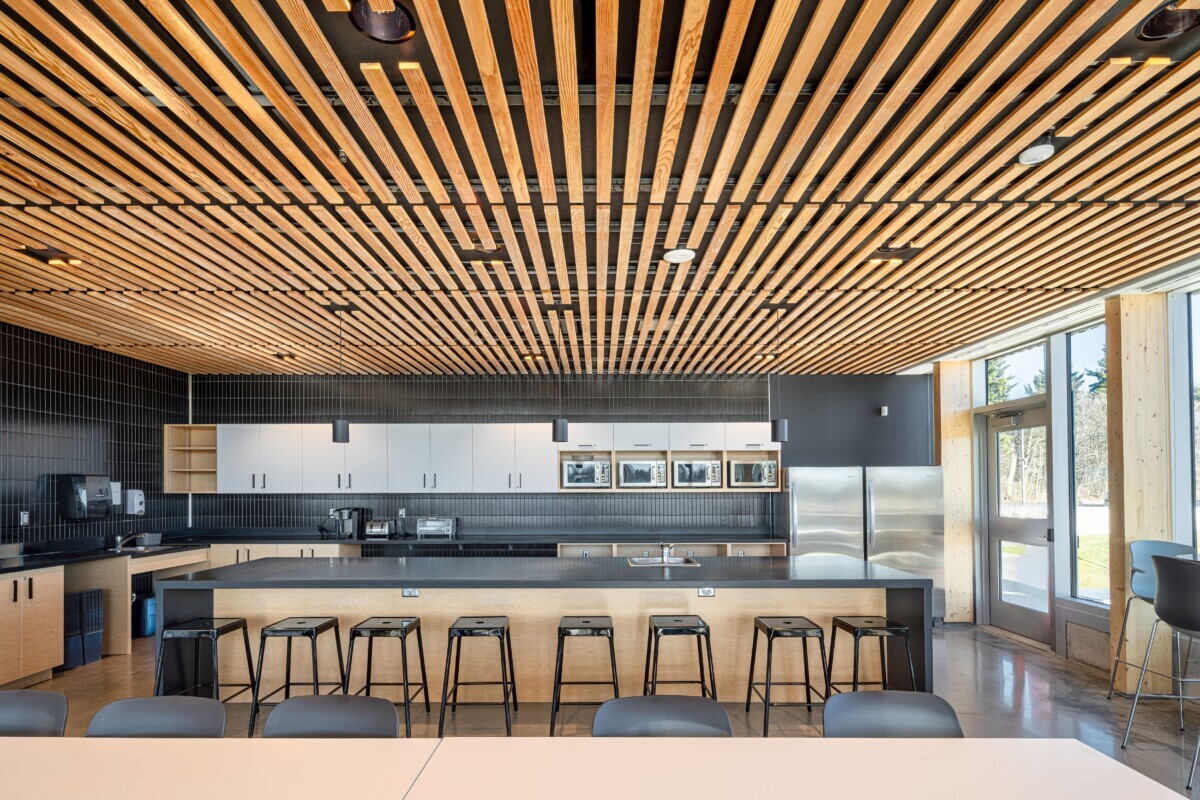 Kitchen area with a ceiling made of using custom wood LINE:Form Linear Planks system from Maxxit.
