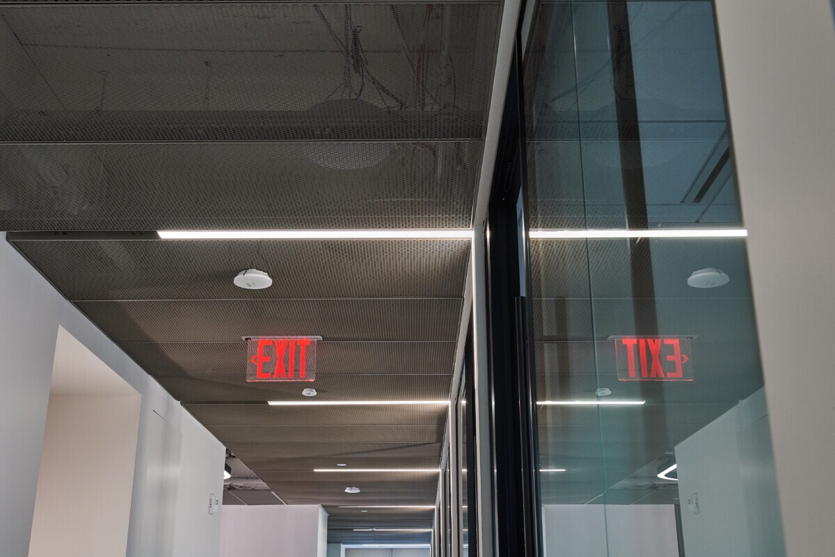 Interior ceiling of Pachulski Stang Ziehl & Jones LLP in New York, USA. Featuring the expanded PANEL:Form Mesh Ceiling Panels. Finished in a custom powdercoat champagne tone, these panels bring a touch of industrial elegance while integrating seamlessly with the space’s high-performance infrastructure.
