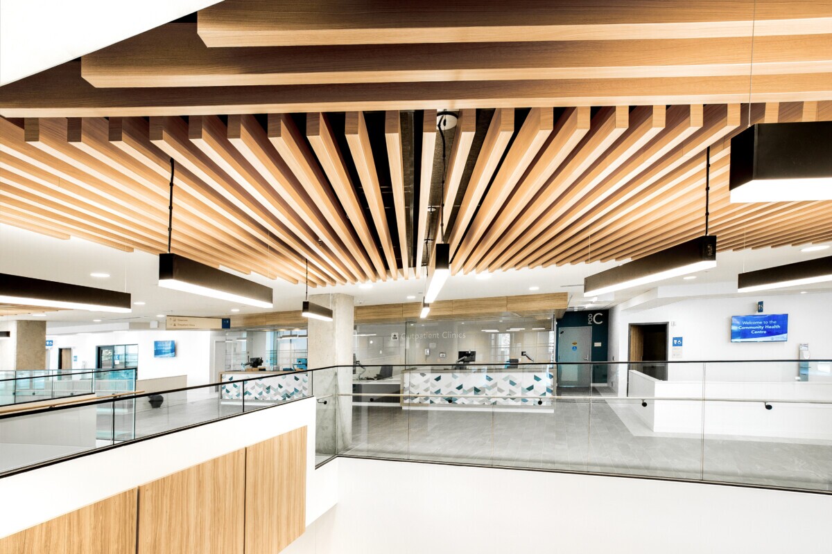 A photo of a healthcare building with Maxxit's LINE:Form Traditional Baffles finished in Champagne Pine at Covenant Health Centre in Edmonton, CA