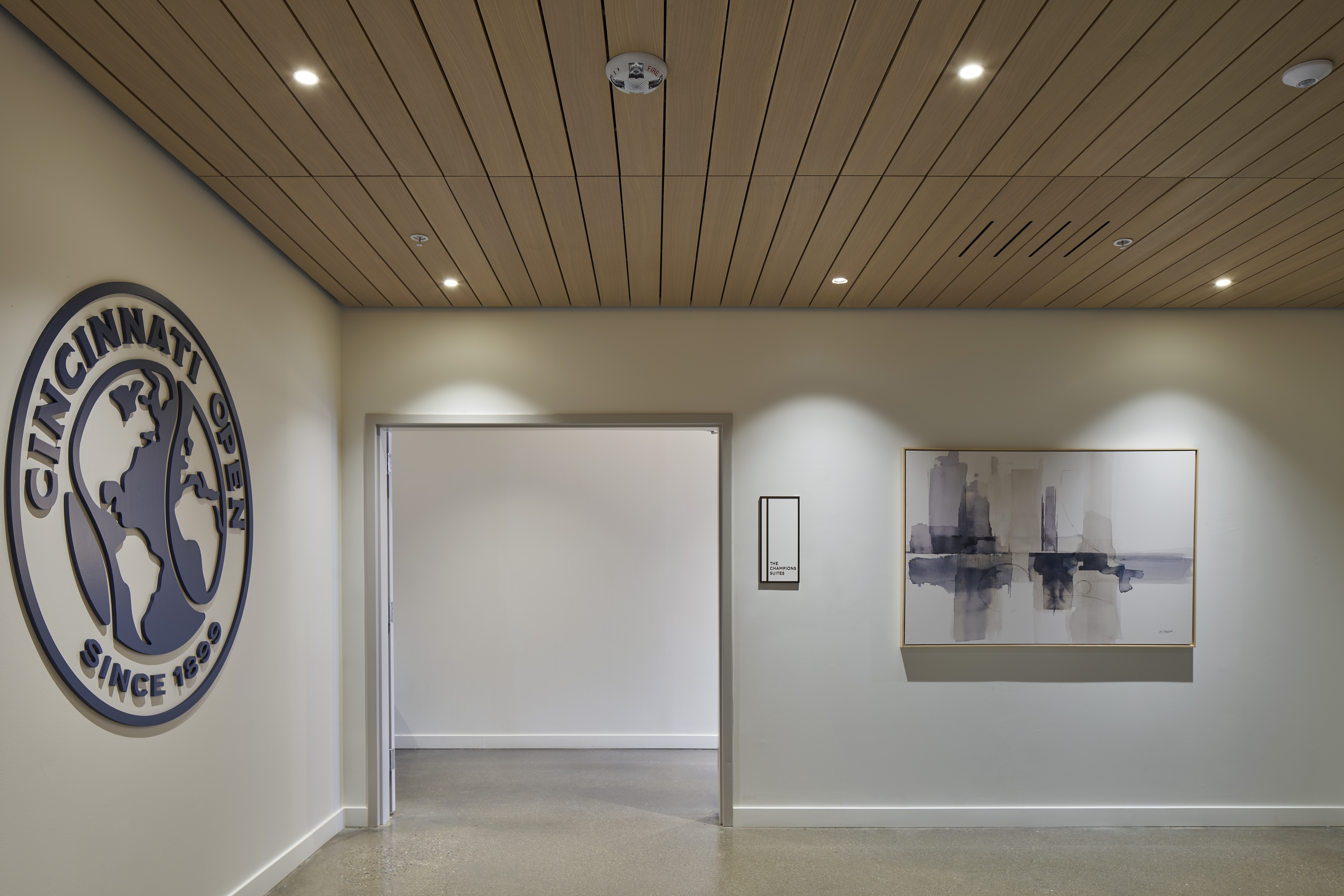 LINE:form linear plank ceilings in a entrance way at the Lindner Family Tennis Center's Suites area and performance center