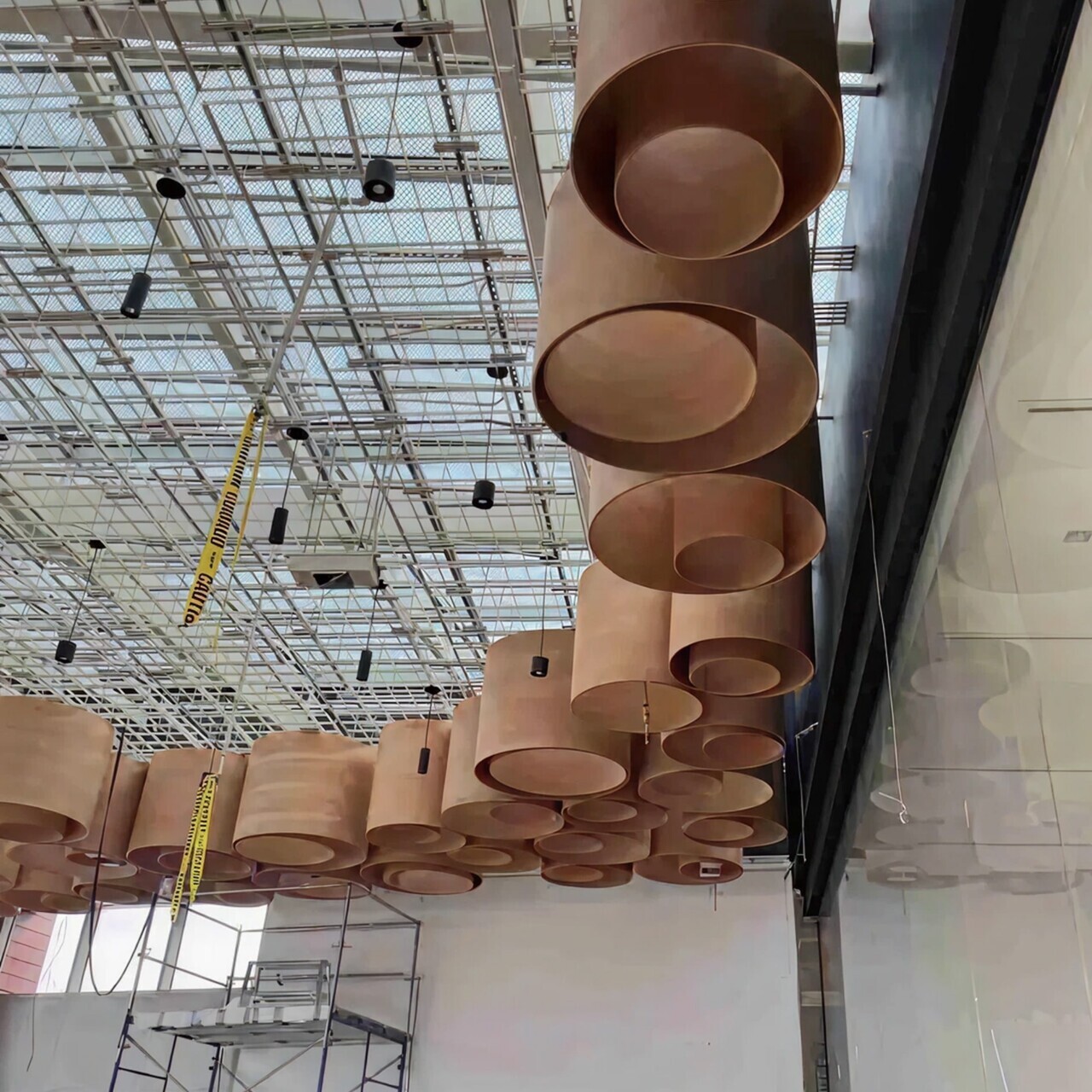 Wood cylinder ceiling panels under construction at Din Tai Fung project site.