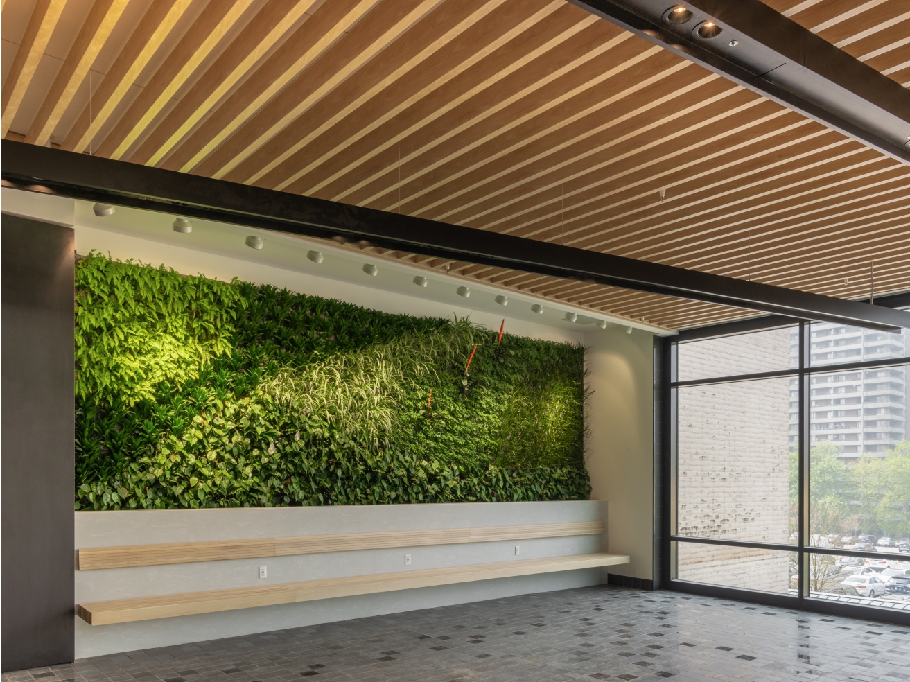 Lougheed Shopping Centre interior showcasing a lush living green wall and linear wood-slat ceiling.