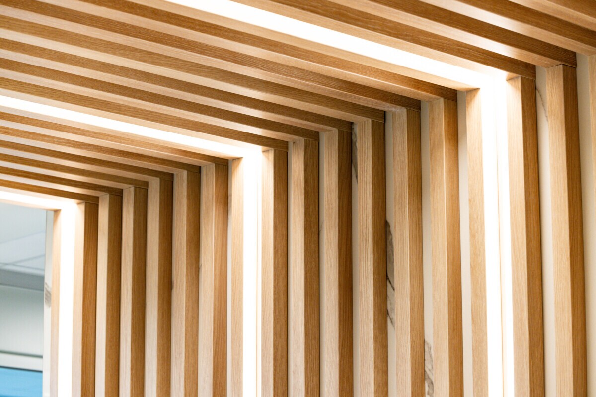 Close-up of Agilis ceiling and wall slats in the Jilani Group reception area.