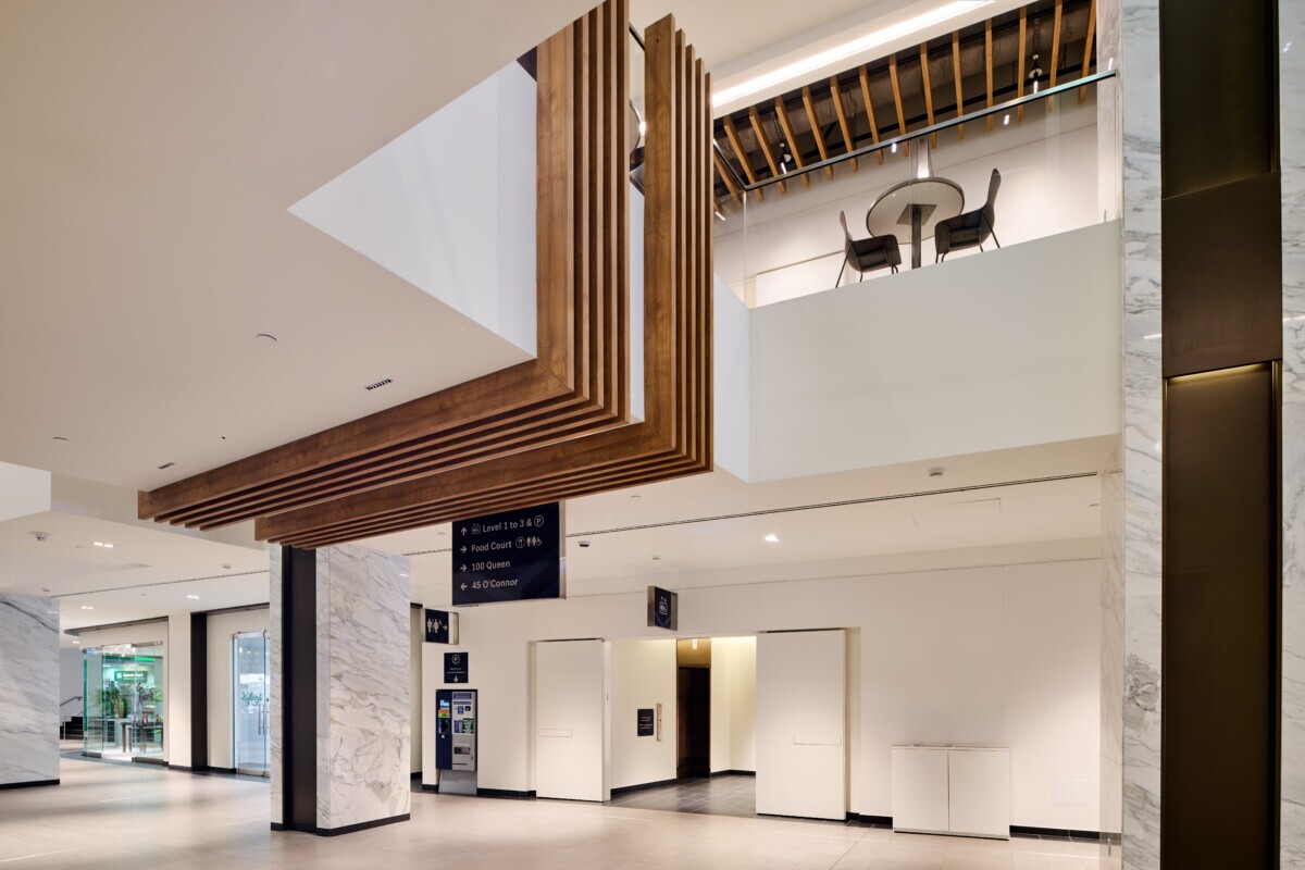 Modern interior at World Exchange Plaza showcasing decorative woodgrain architectural ceiling baffles.