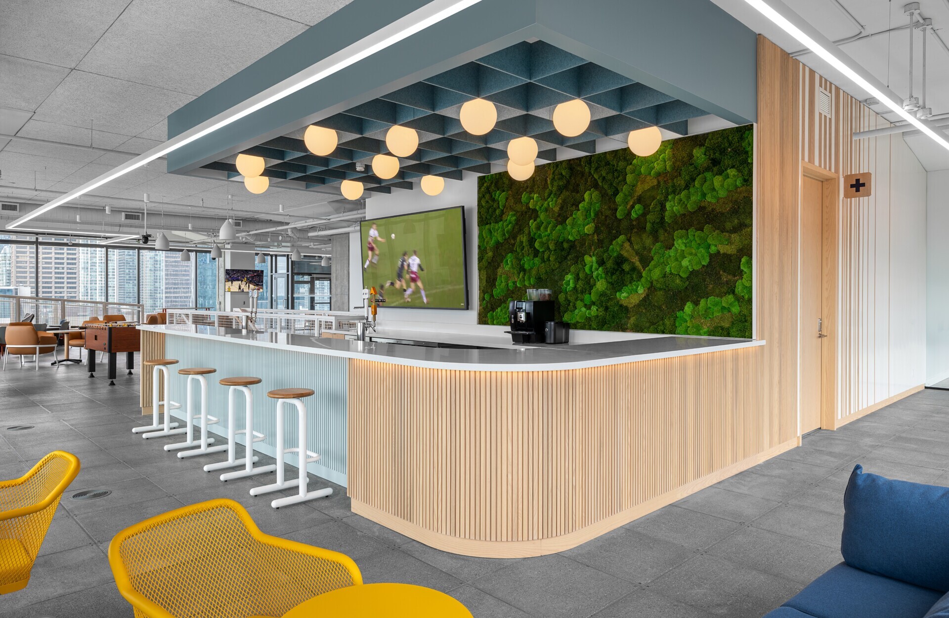 theScore Toronto office featuring a bar area with Silentia Networks acoustic felt ceiling baffles.