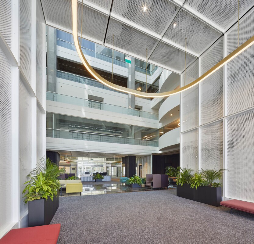 Spacious enterance in to lobby of a building using PANEL:form design perforated ceiling wall panels