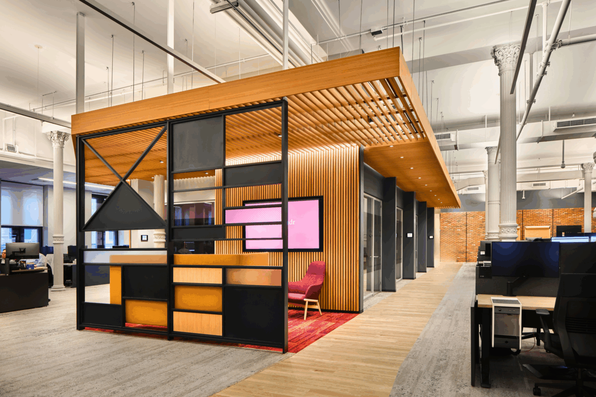 Xandr modern open office space with wooden meeting pod, glass walls, and contemporary furniture.