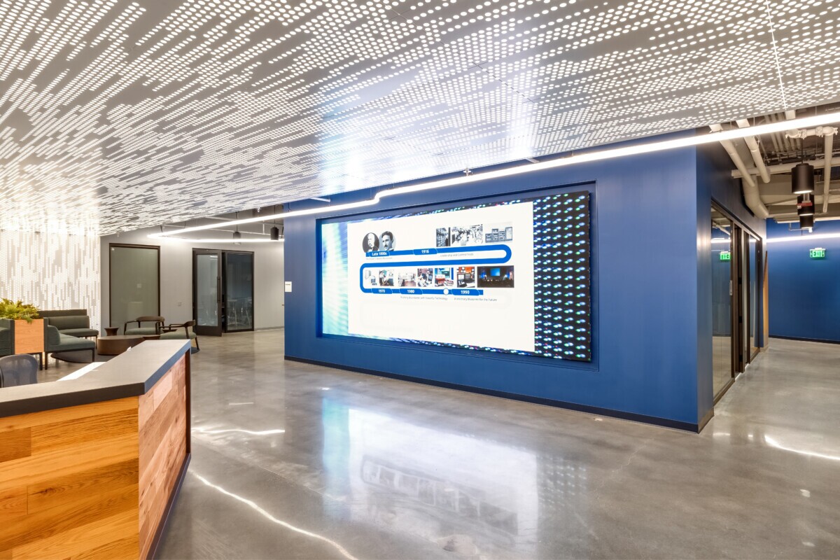 Emerson Electric lobby featuring Agilis backlit perforated ceiling panels and digital display wall.
